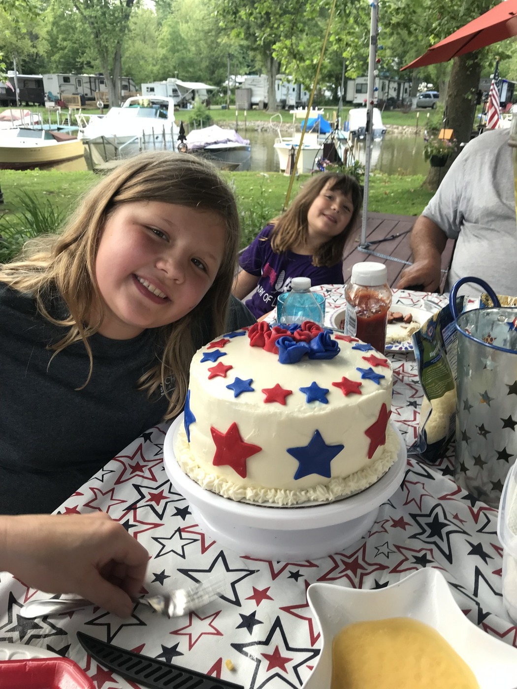 White Americana cake with red and blue stars and roses