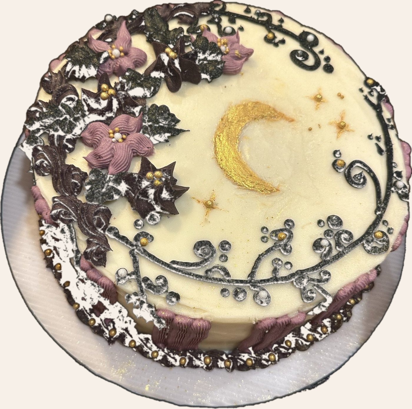 Cream celestial cake with gold moon, stars, and lavender florals