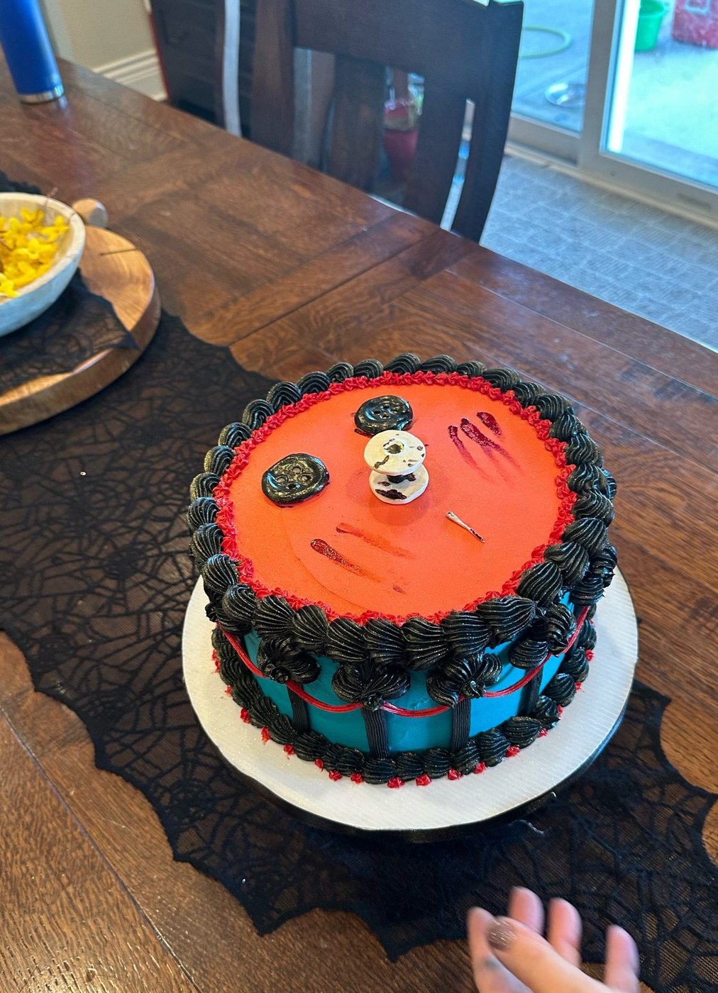 Coraline Halloween cake with button eyes and teal stripes