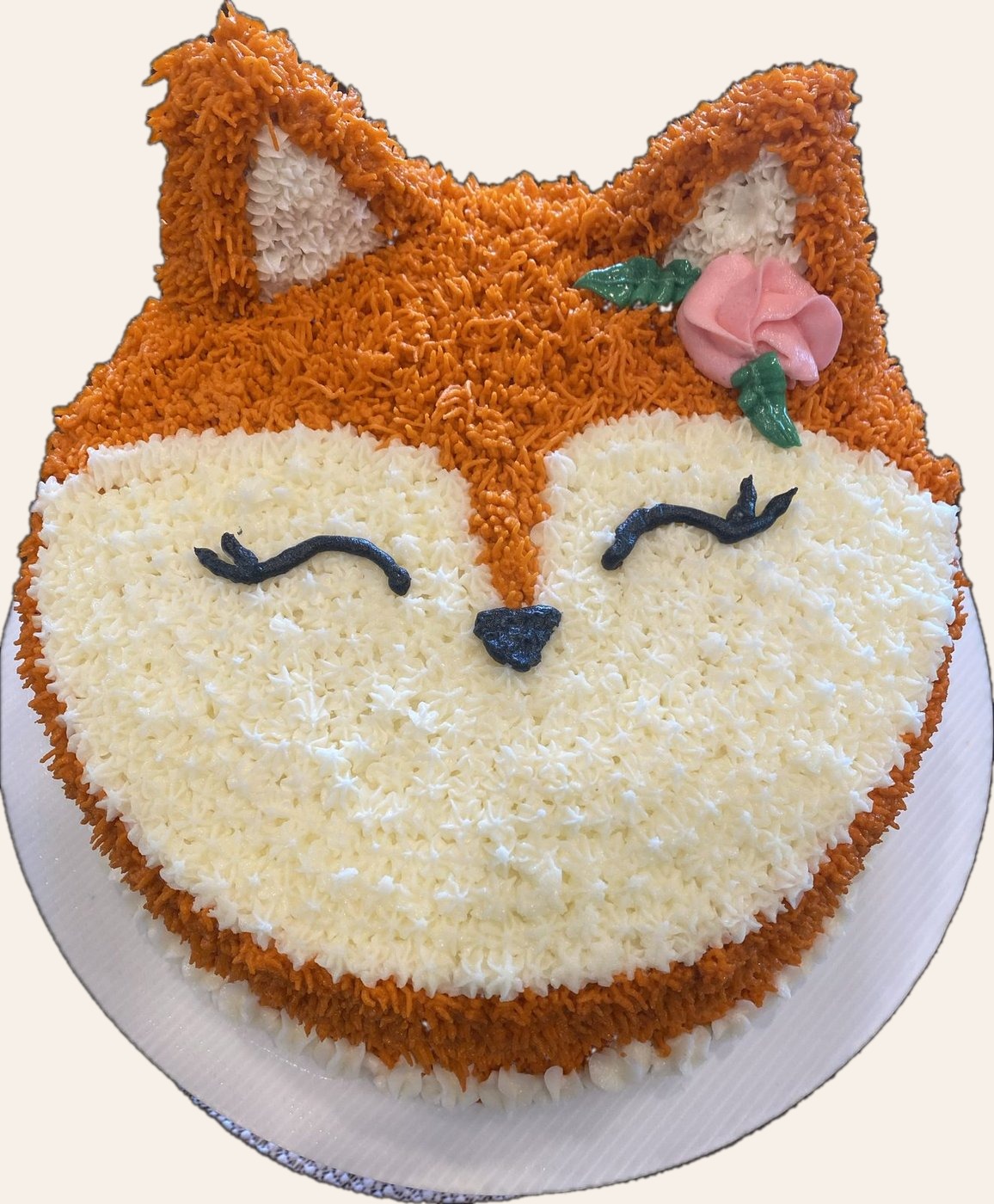 Sleeping fox head cake in orange and white buttercream